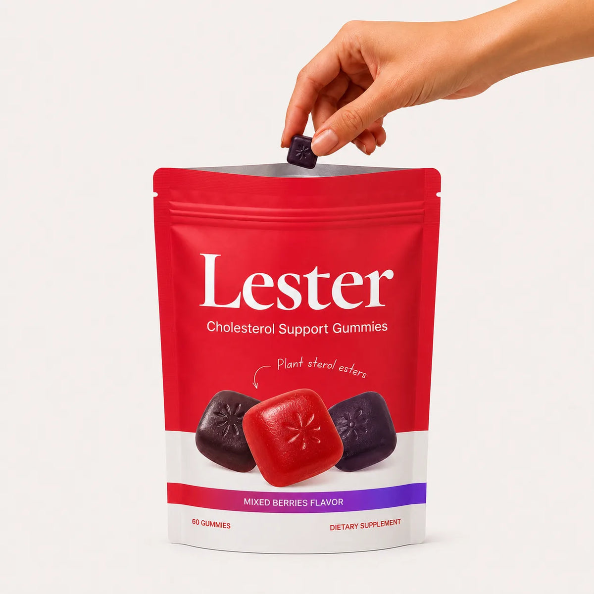 Hand dropping a gummy into a Lester cholesterol support gummies pouch, front of pack