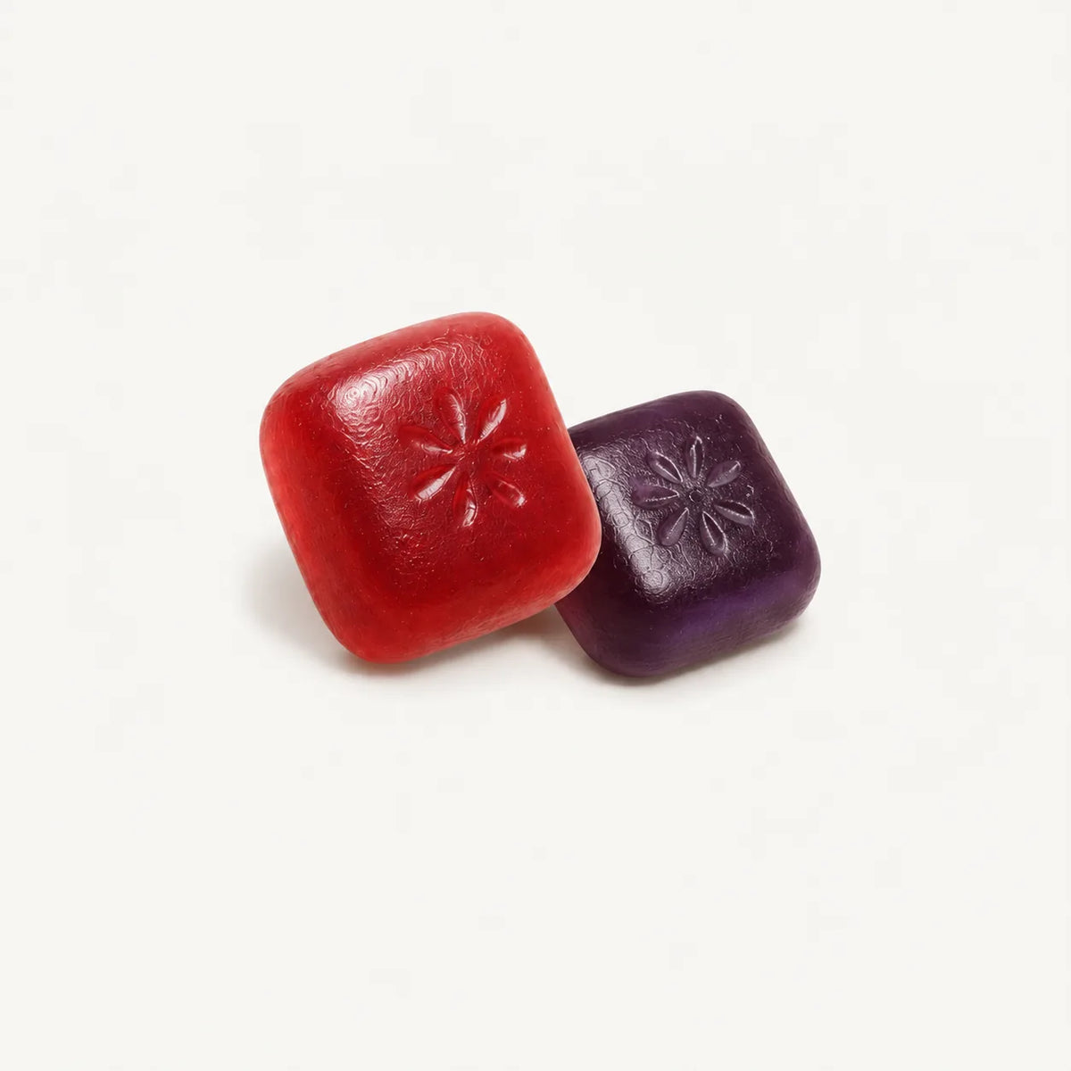 Close-up of red and purple Lester cholesterol support gummies with plant sterol esters